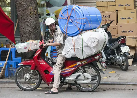 Hanoi street scene with motorbikes loaded with goods