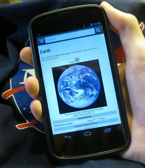 Illustration of a hand tapping install on an Android phone