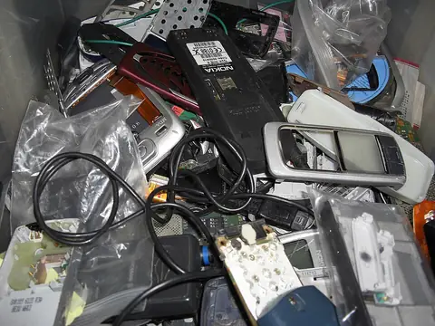 Pile of old and broken mobile phones and parts